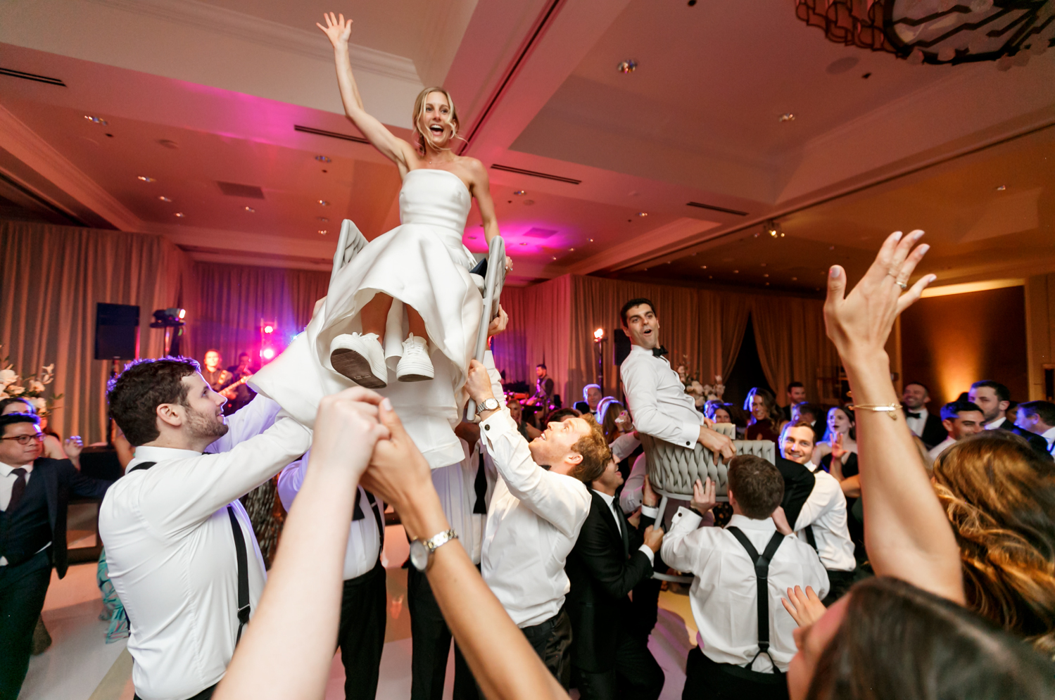 Guests dance the Horah and the bride and groom are lifted into the air on chairs