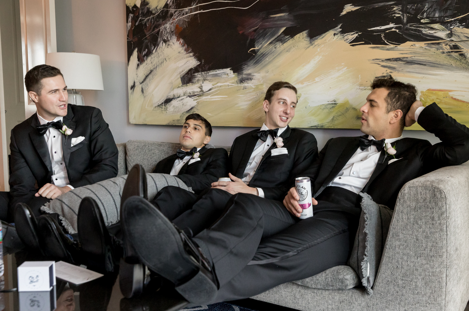 groomsmen drinking while getting ready 