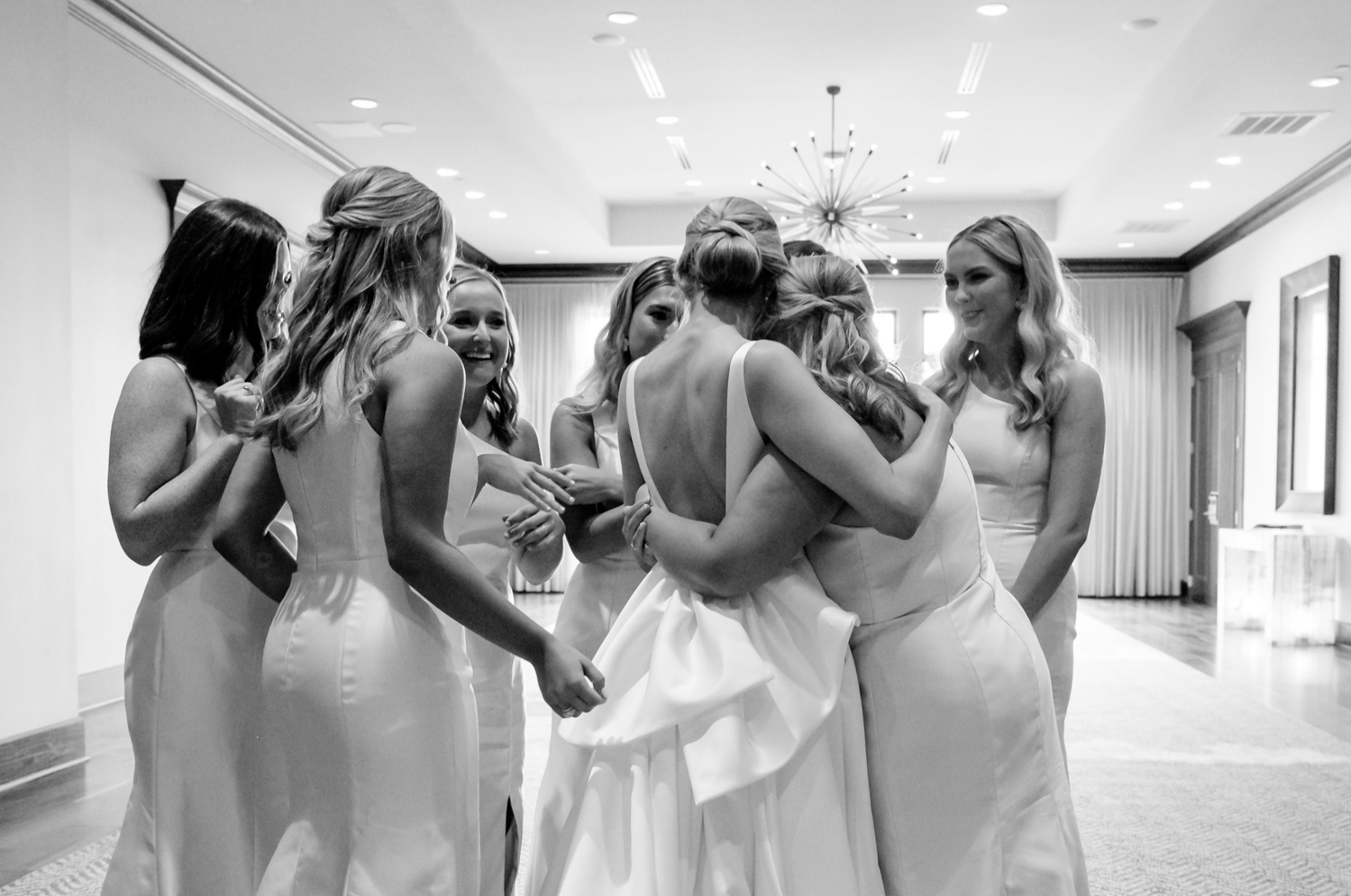 bridesmaids all hugging bride before wedding 