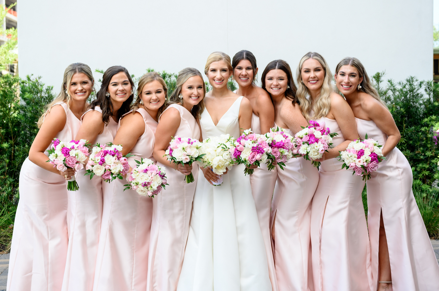 bride and her bridesmaids in light pink bridesmaids dress 