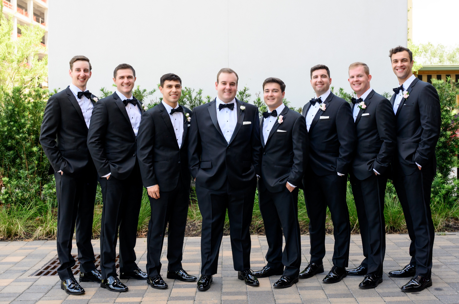 groomsmen and groom posing 