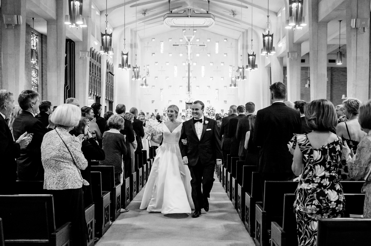 bride and groom walk back down the aisle as husband and wife 