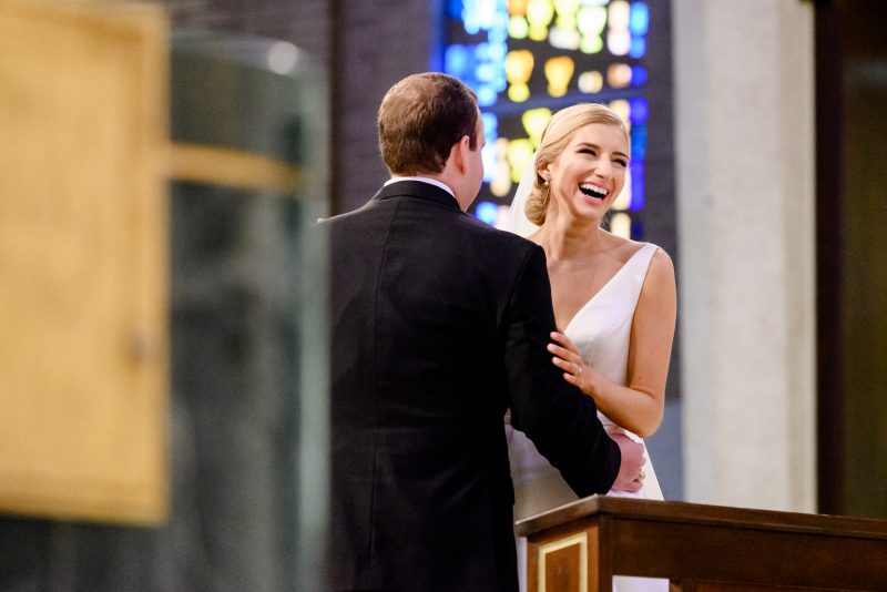Bride laughing during her ceremony at St. Michaels catholic church in Houston