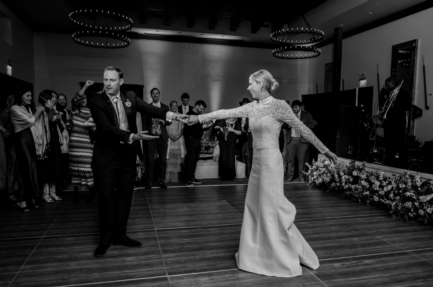 groom spins the bride during their first dance as a married couple 