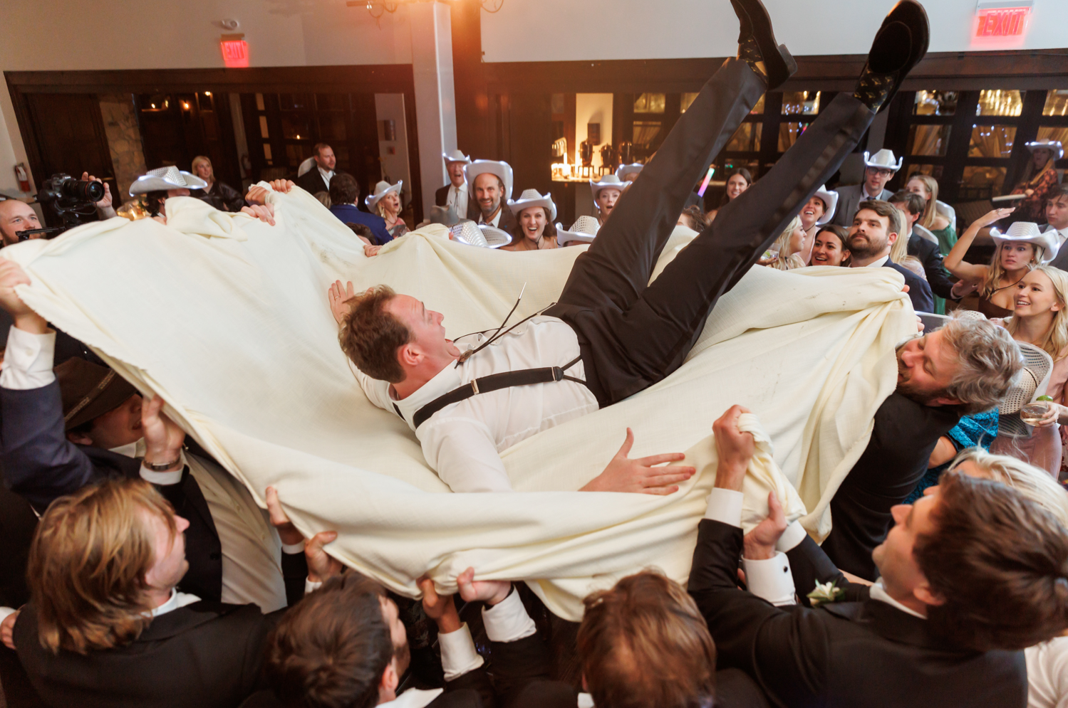 groom on a sheet in the middle of the dance floor 