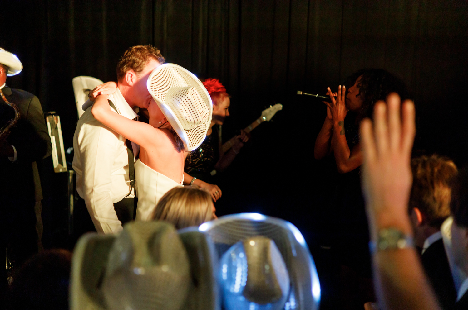 bride and groom kissing on stage