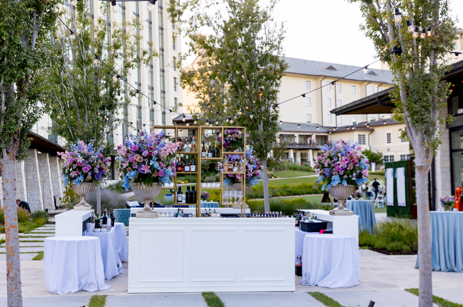 The bar and beautiful blue and purple flower arrangements outside before the reception