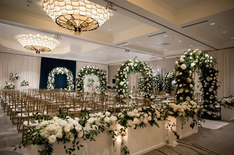 White and green floral wedding ceremony inside the Four Seasons Austin Ballroom