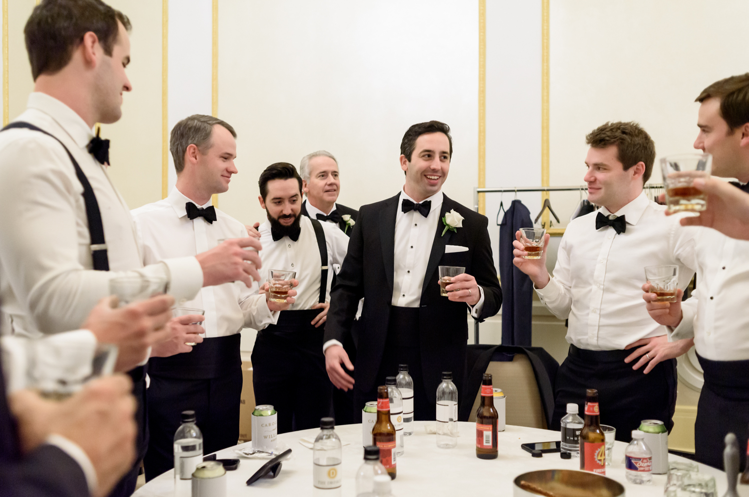The groomsmen drink before the wedding and toast to the groom.
