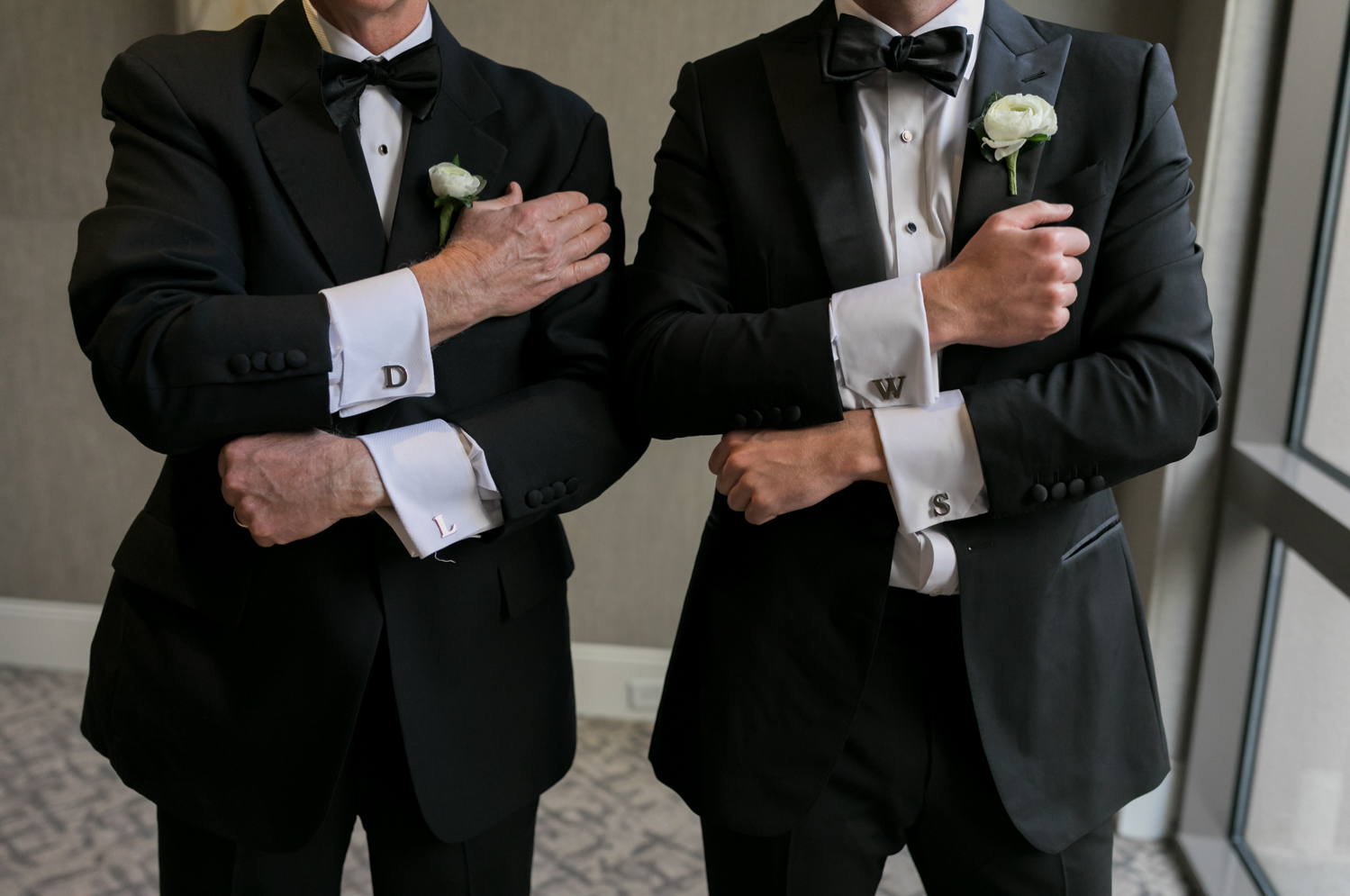 The groom and his father show off their custom monogrammed cufflinks.