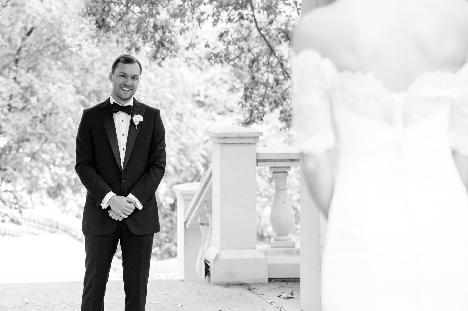 The groom smiles as he sees his bride for the first time