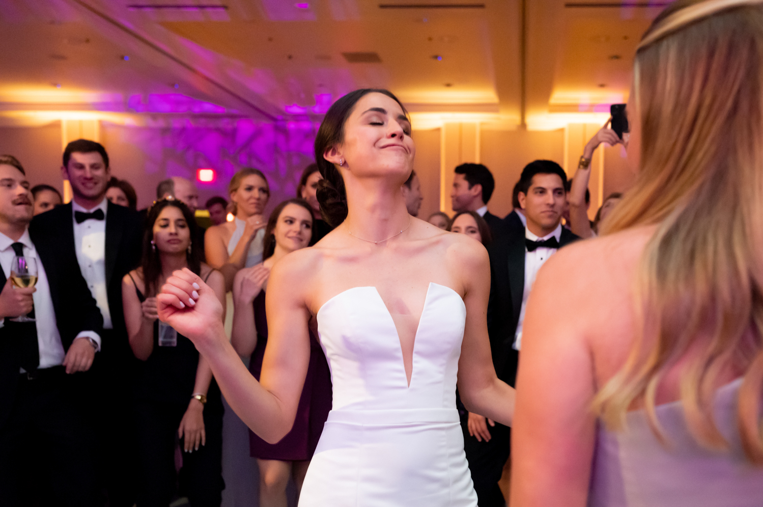 The bride dances with her friends at the reception.