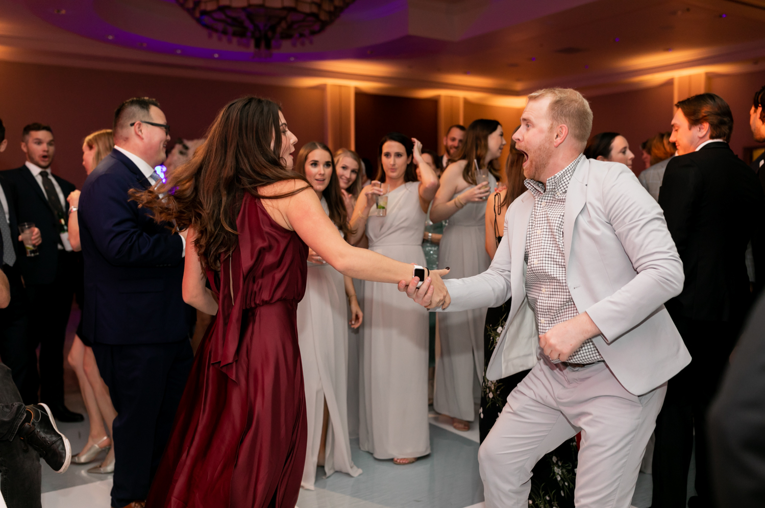 Guests laugh and dance at the reception.