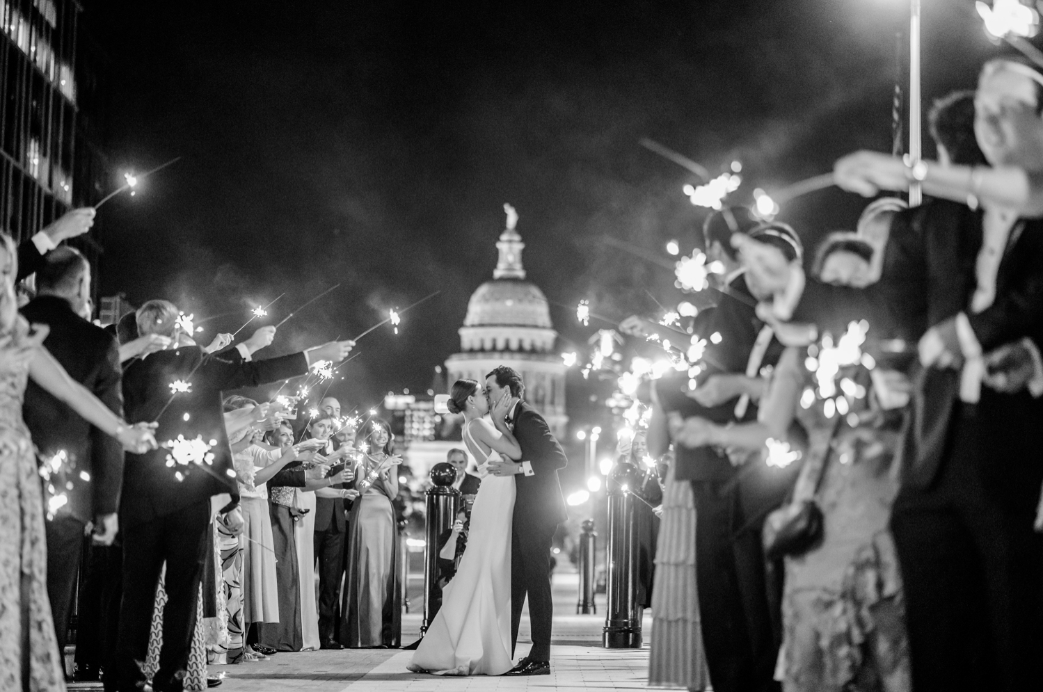 bride and groom kissing in front of the Texas Capitol building
