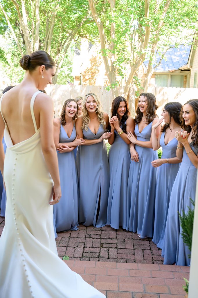 bridesmaids seeing the bride in her dress
