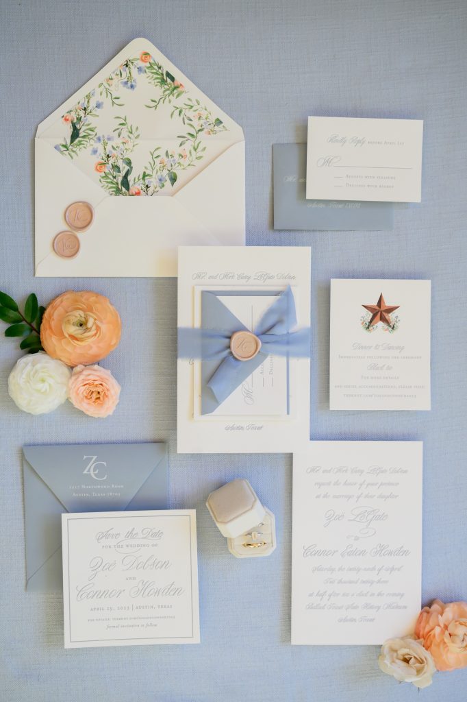 light blue wedding invitations with hints of pastel orange