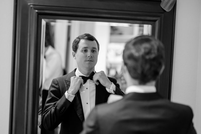 groom putting on his bowtie