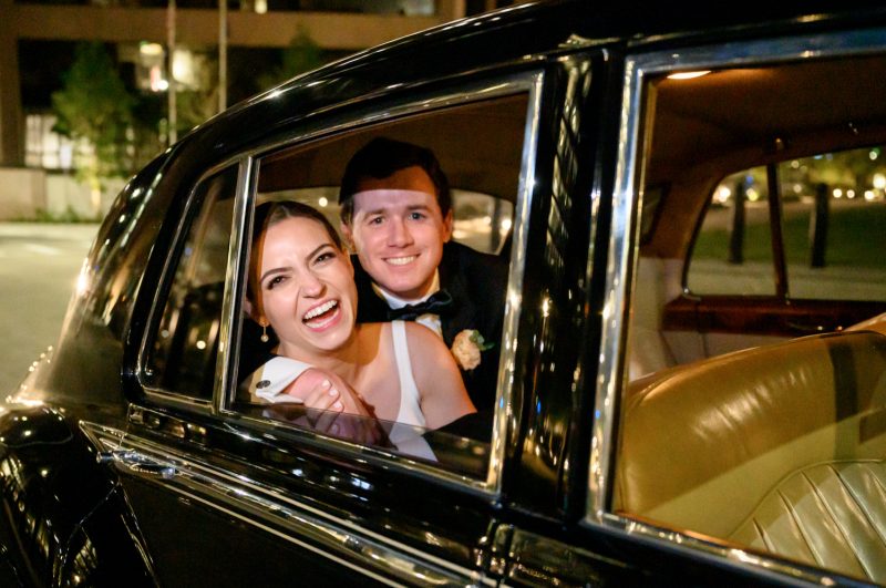 bride and groom leaving in their getaway car