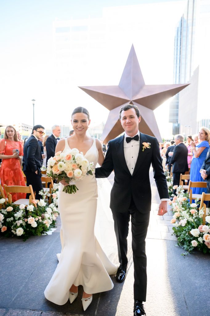 bride and groom smiling as they exit the ceremony