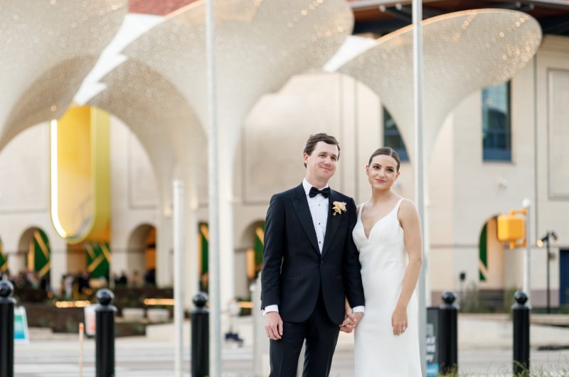 bride and groom portrait in front of the Blanton Museum