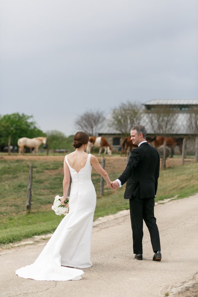 bride and groom holding hands