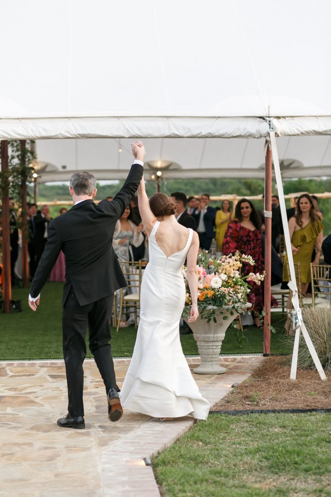 bride and groom entering the reception