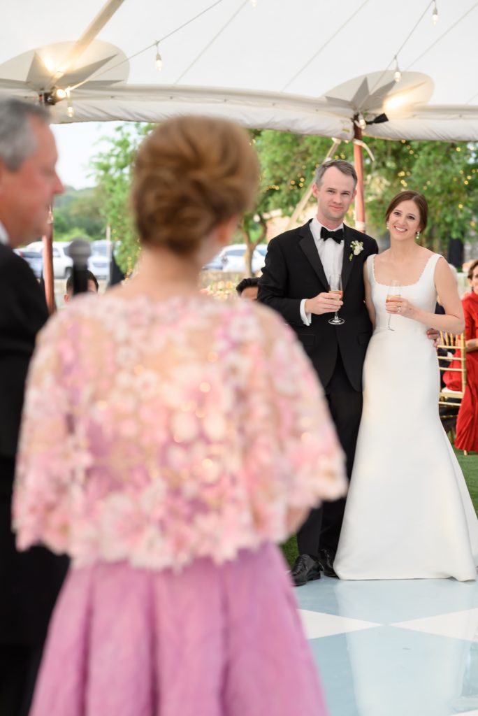 bride and groom listening to toasts