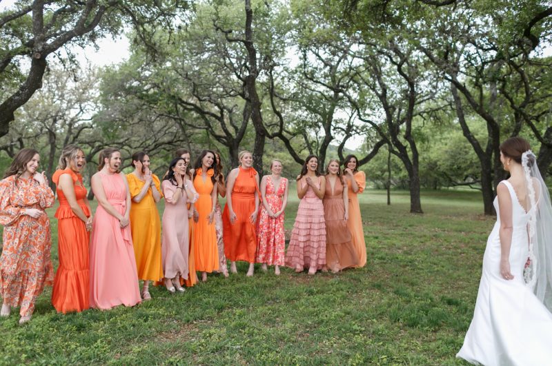 bridesmaids seeing the bride in her wedding dress