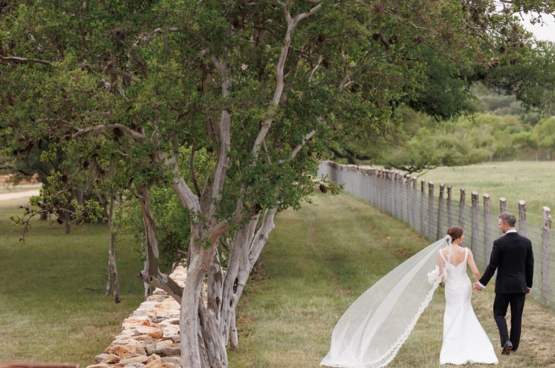 bride and groom holding hands