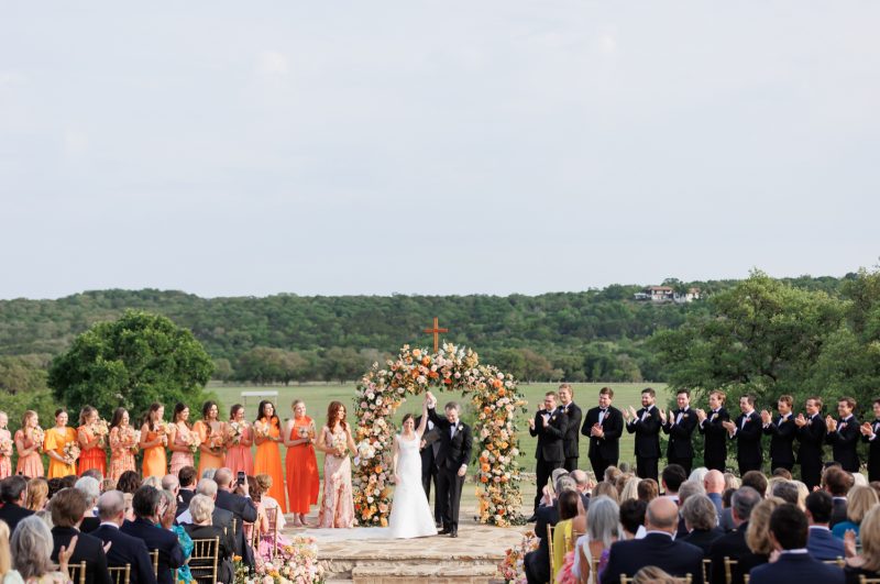 bride and groom celebrating at the altar