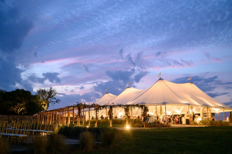 tent lights up under the sunset