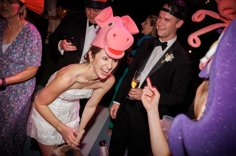 bride dancing with foam pig hat on
