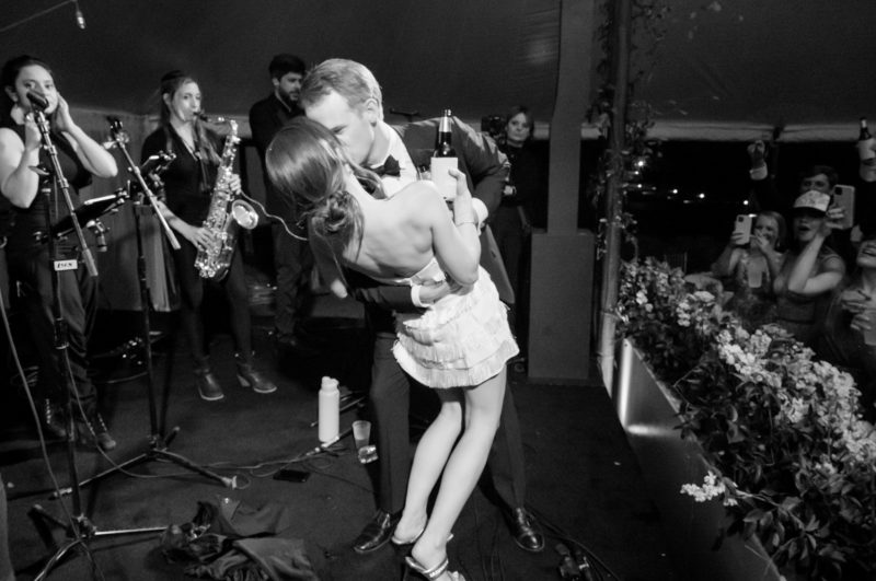 bride and groom kissing on stage