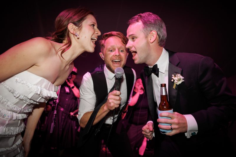 bride and groom singing with the band