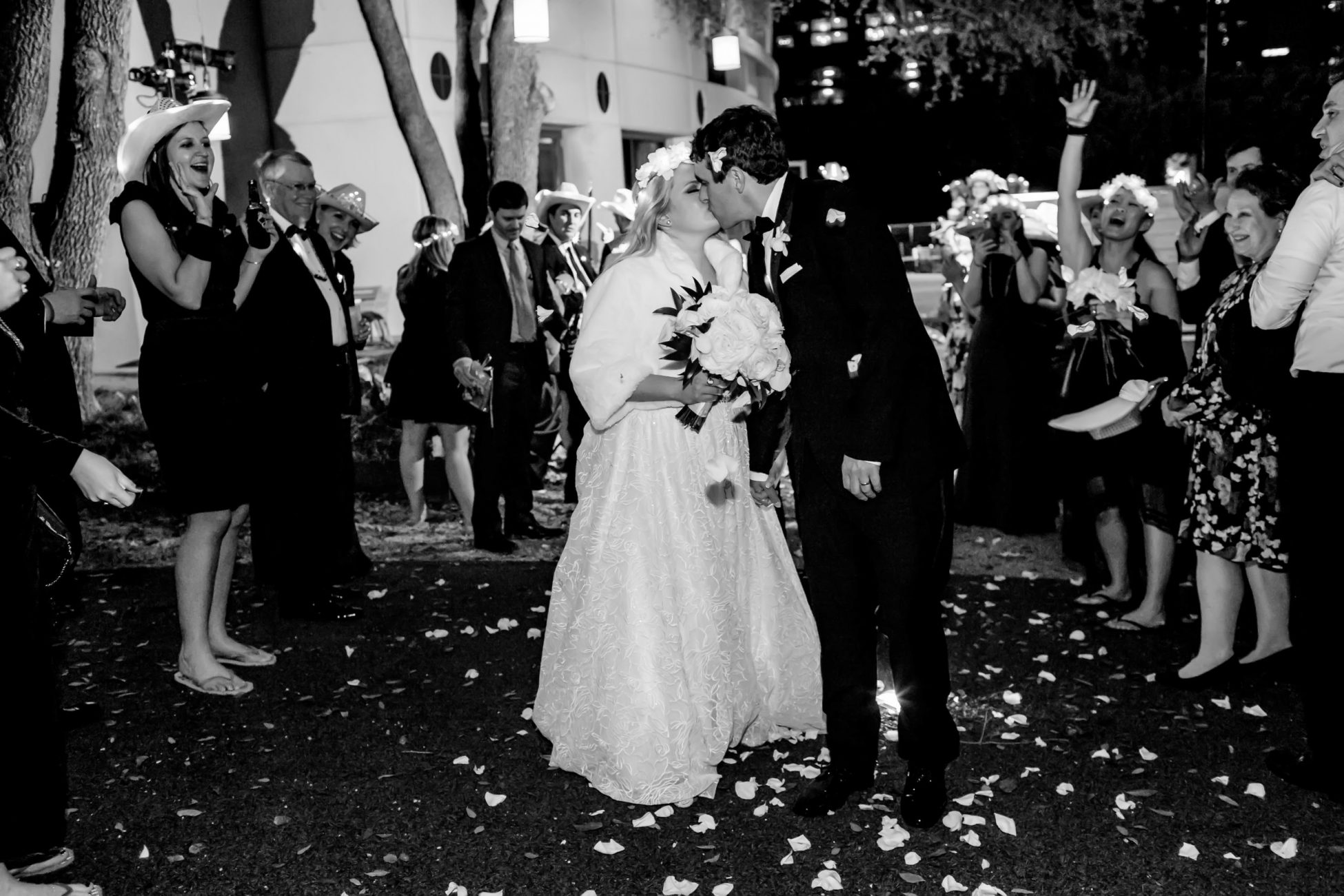 bride and groom kissing as they exit