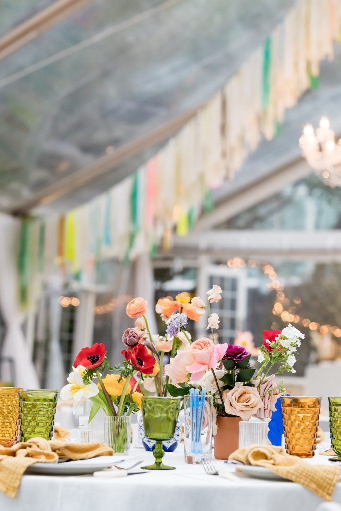 colorful glasses with colorful florals at rehearsal dinner