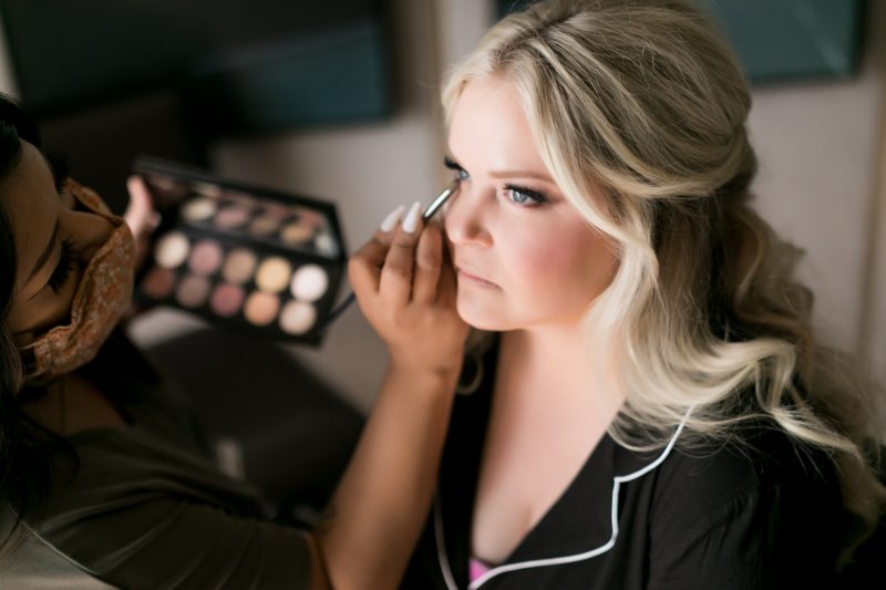 bride getting makeup put on her