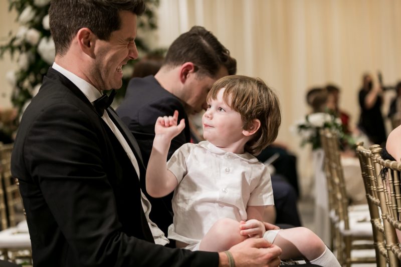 child sitting on the lap of a guest