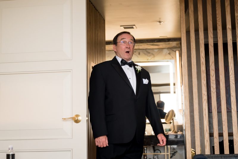father of the bride seeing his daughter in her wedding dress
