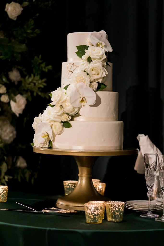 white tiered wedding cake with white florals