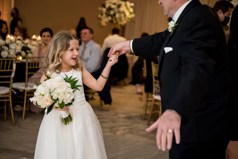 flower girl dancing with the father of the bride