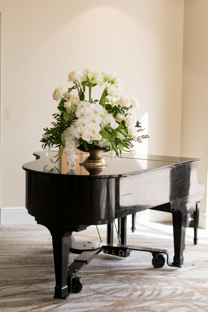 white florals on top of a piano