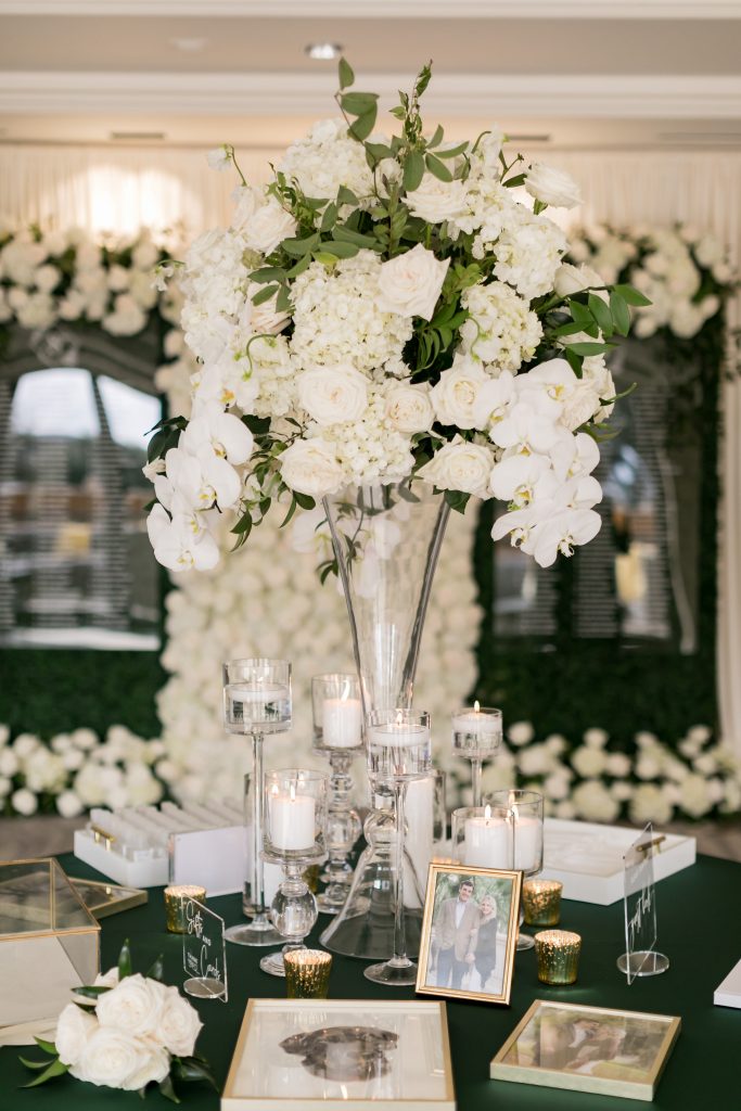 white floral centerpiece with green accents