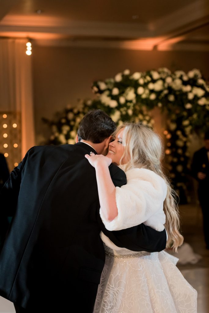 bride and groom hugging during first dance