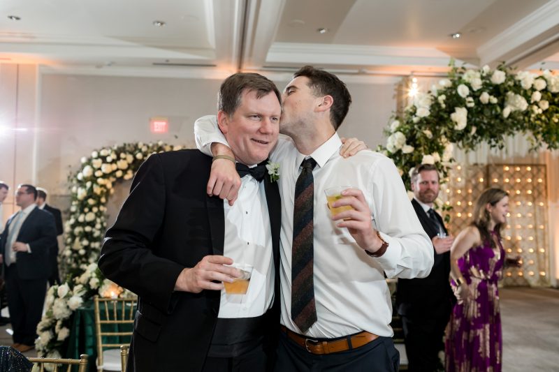 wedding guests enjoying the reception with drinks in their hands