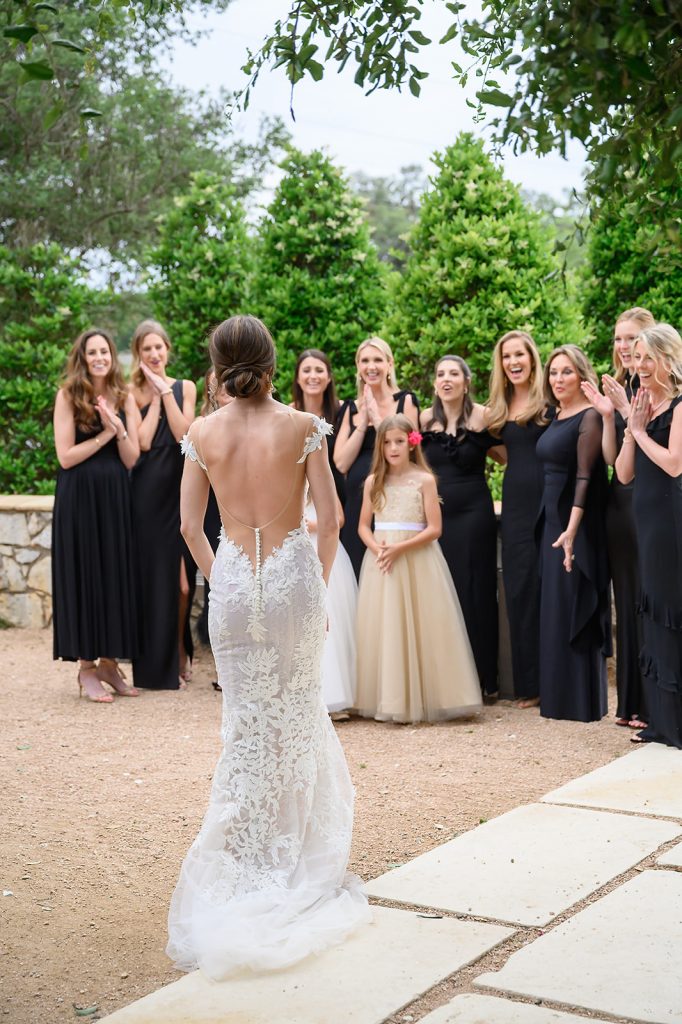 bride showing her bridesmaids her dress