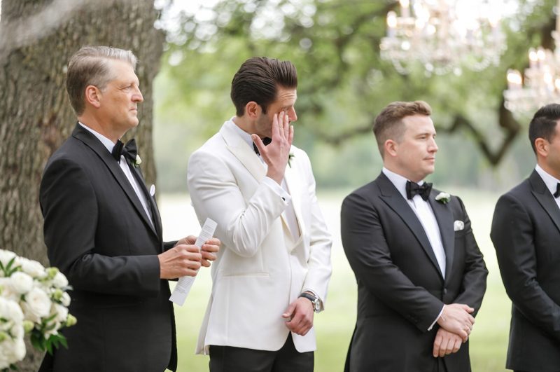 groom crying as his bride walks down the aisle