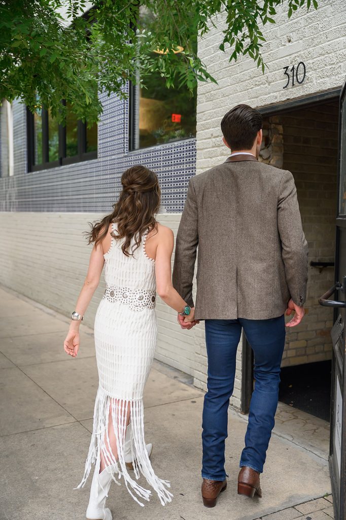 bride and groom walking into their rehearsal dinner
