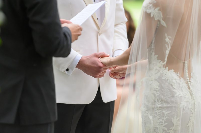 bride and groom holding hands at the altar