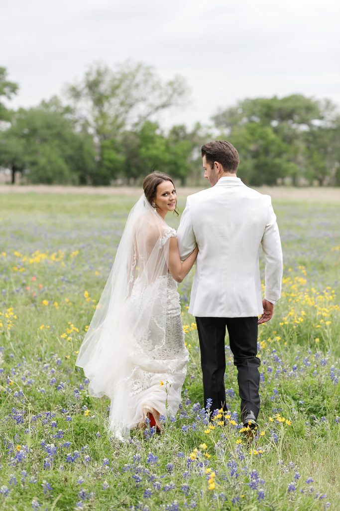 bride and groom portraits in field of wildflowers